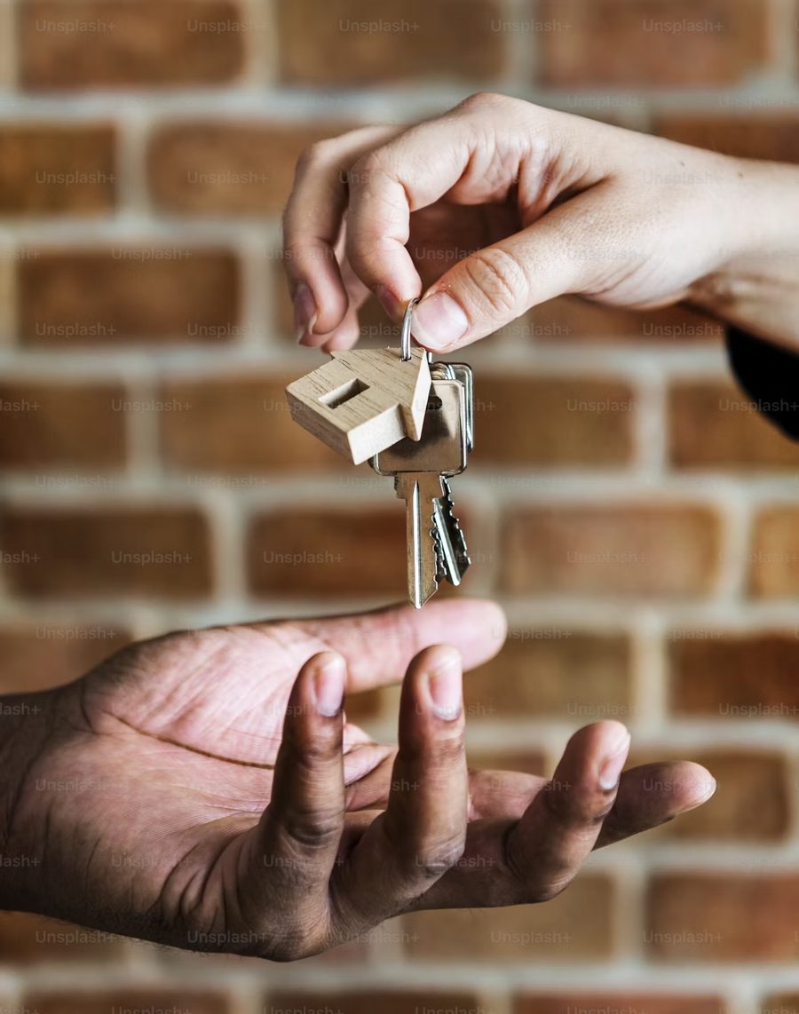 Keys being handed over outside a London property